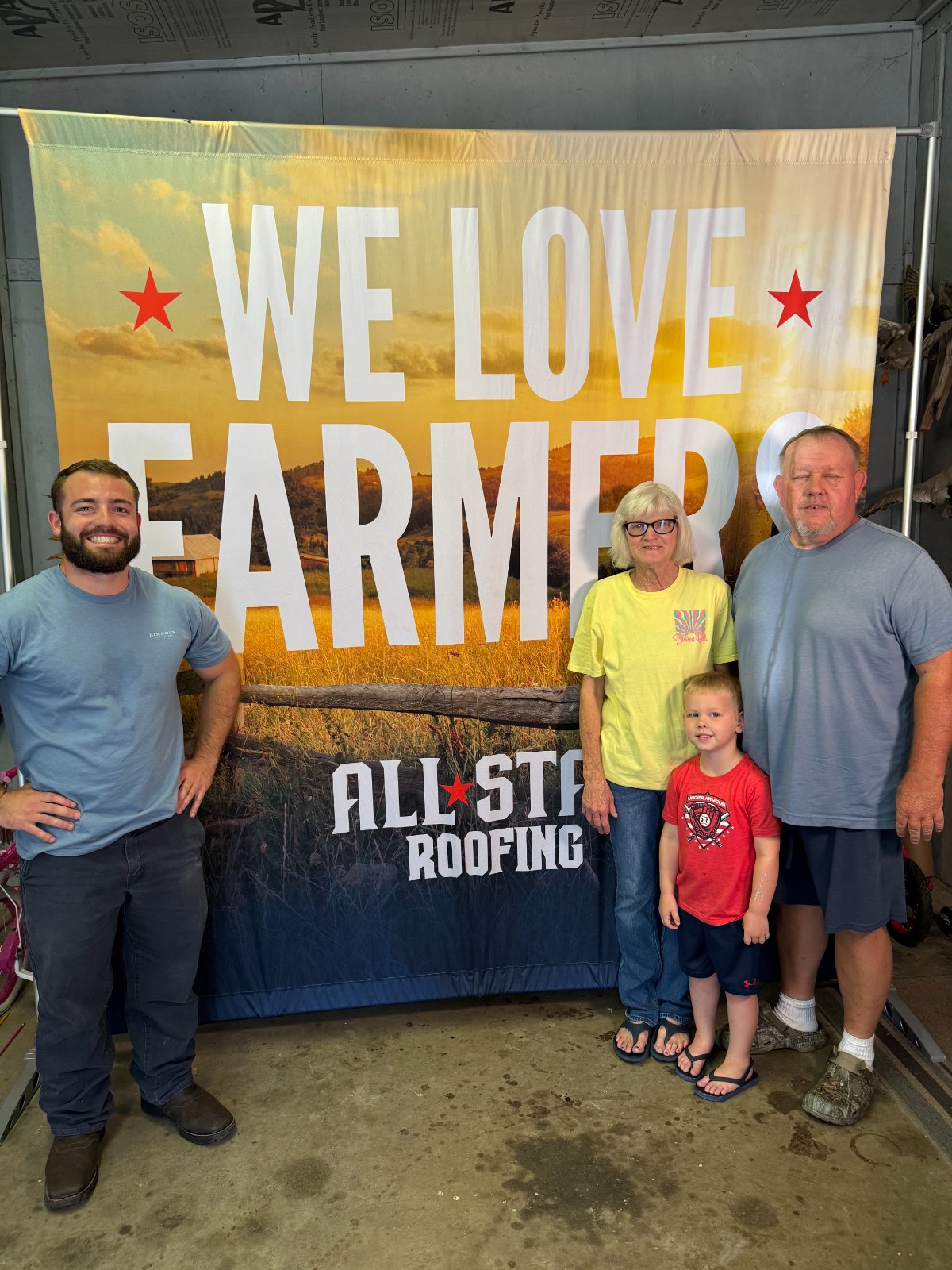 The Donna family with the All Star crew in front of the We Love Farmers banner