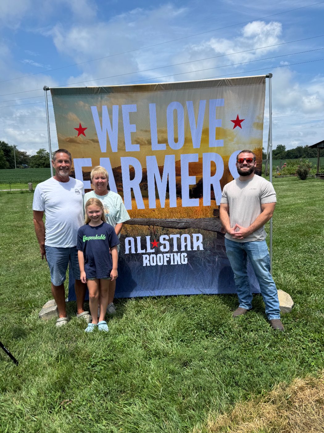 The Dooley family at the We Love Farmers banner